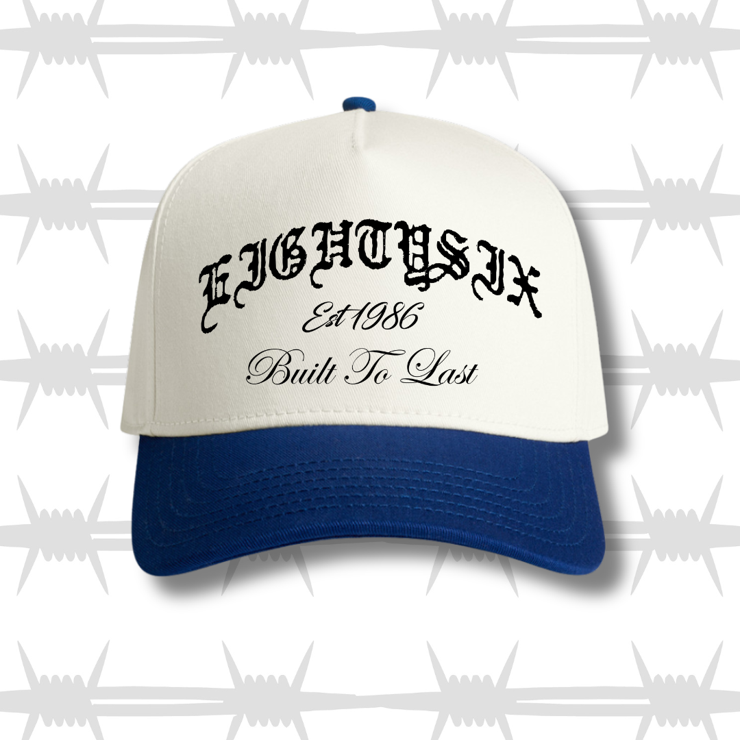 two tone cap with blue peak featureing the eightysix logo and built to last script