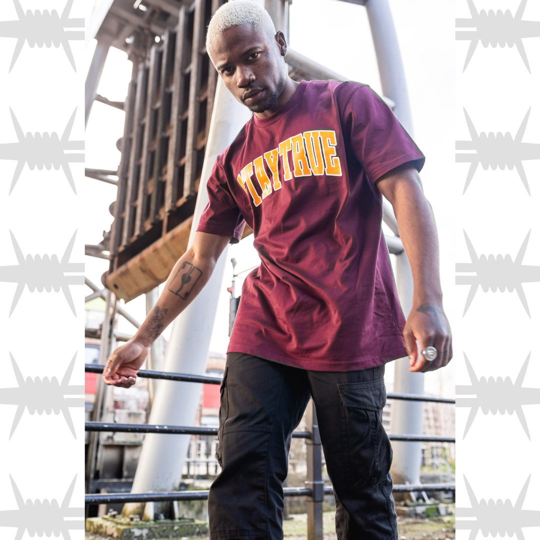 Eightysix stay true varsity t-shirt in burgundy worn by tattooed alternative model