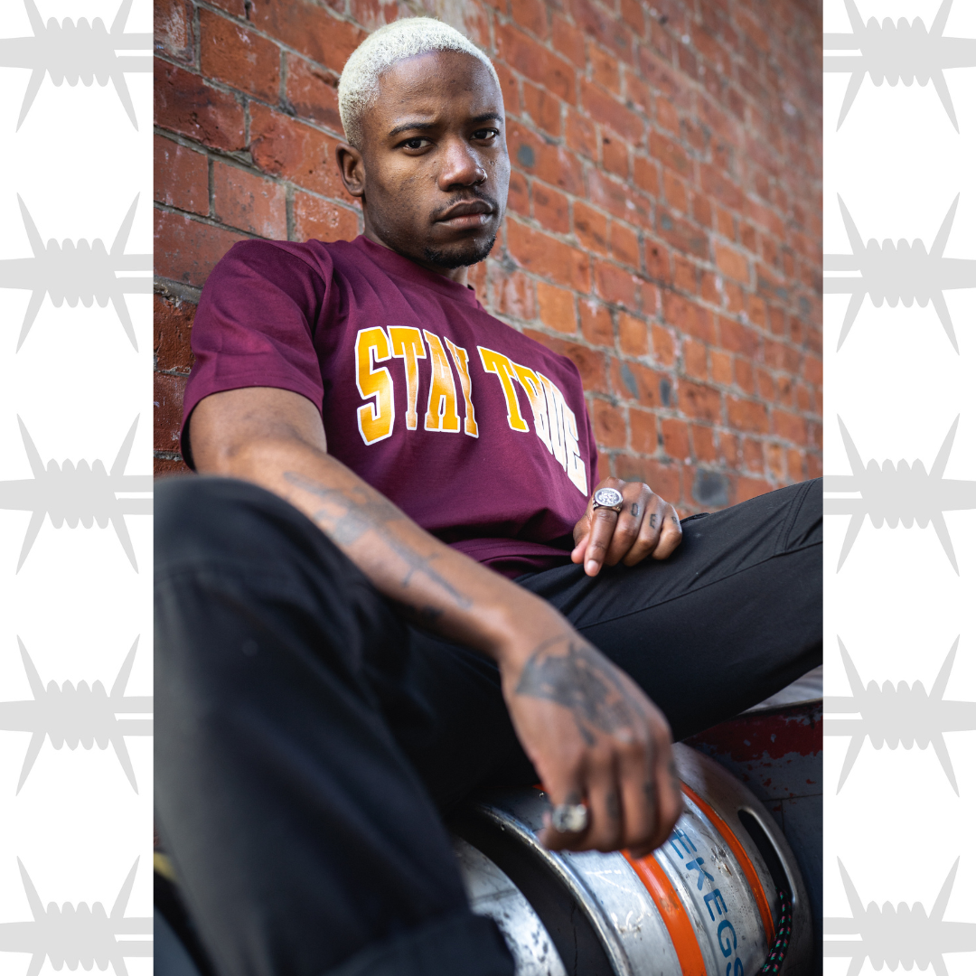 Eightysix streetwear stay true varsity t-shirt in burgundy worn by tattooed model
