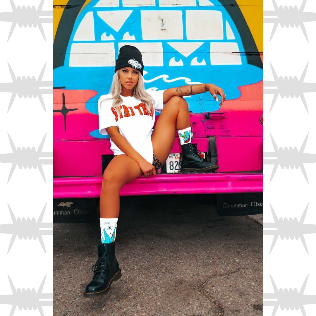 Stay true varsity graphic tee in white worn by alternative lifestyle streetwear model