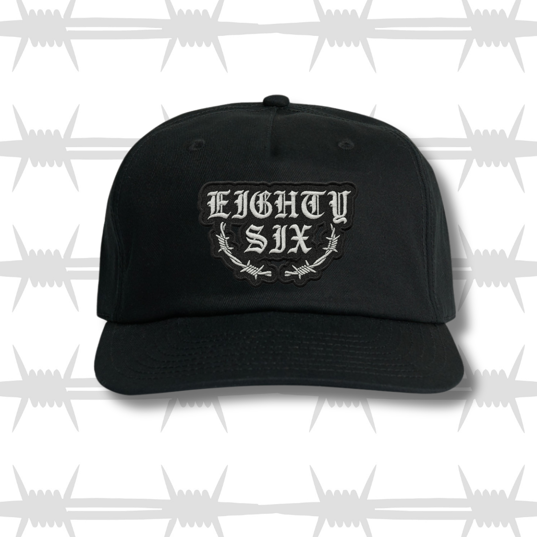 Black baseball cap with embroidered eightysix logo with a barbed wire accent and a tattoo style built to last script front shot.