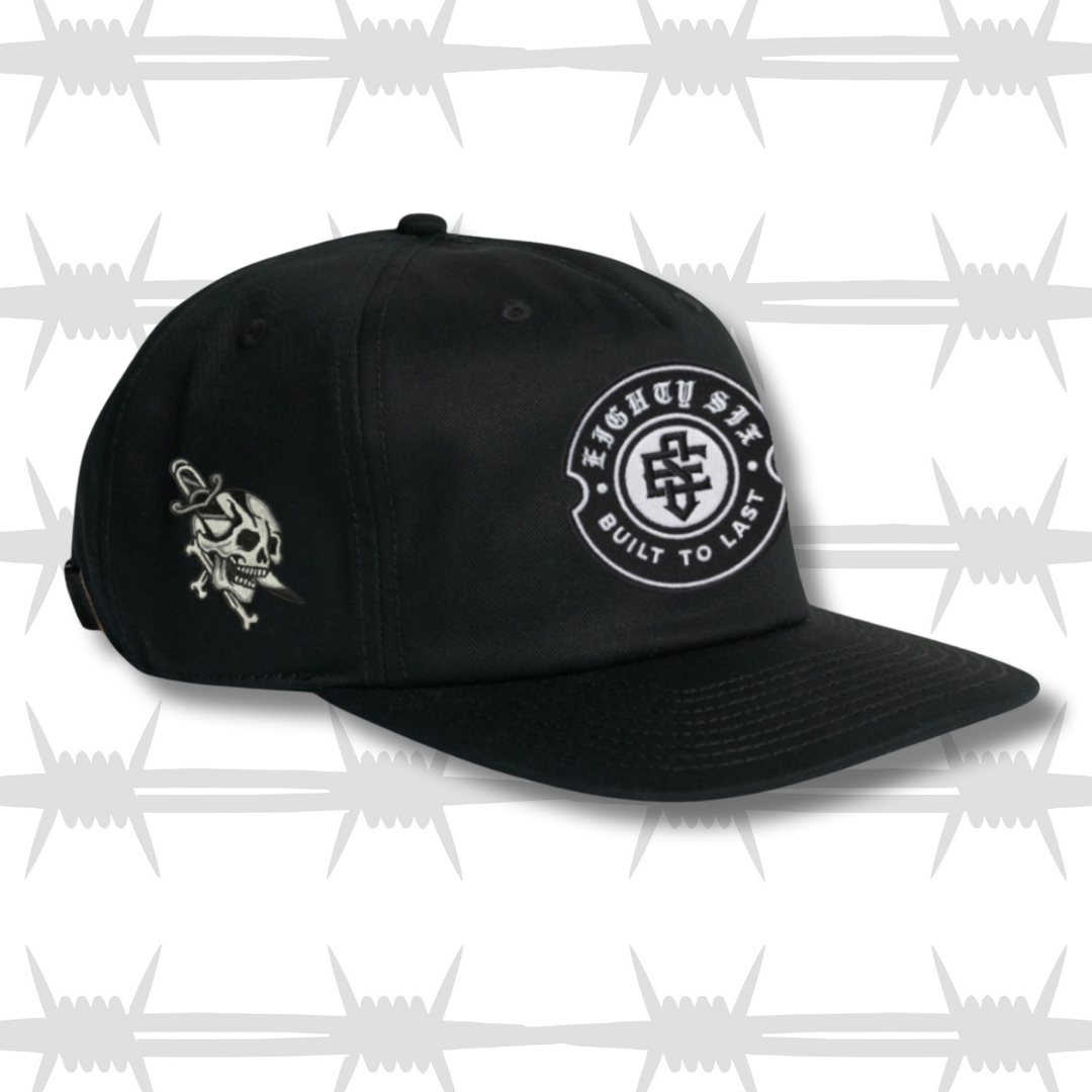 Black work cap with embroidered crest eightysix logo with dagger and skull tattoo inspired design