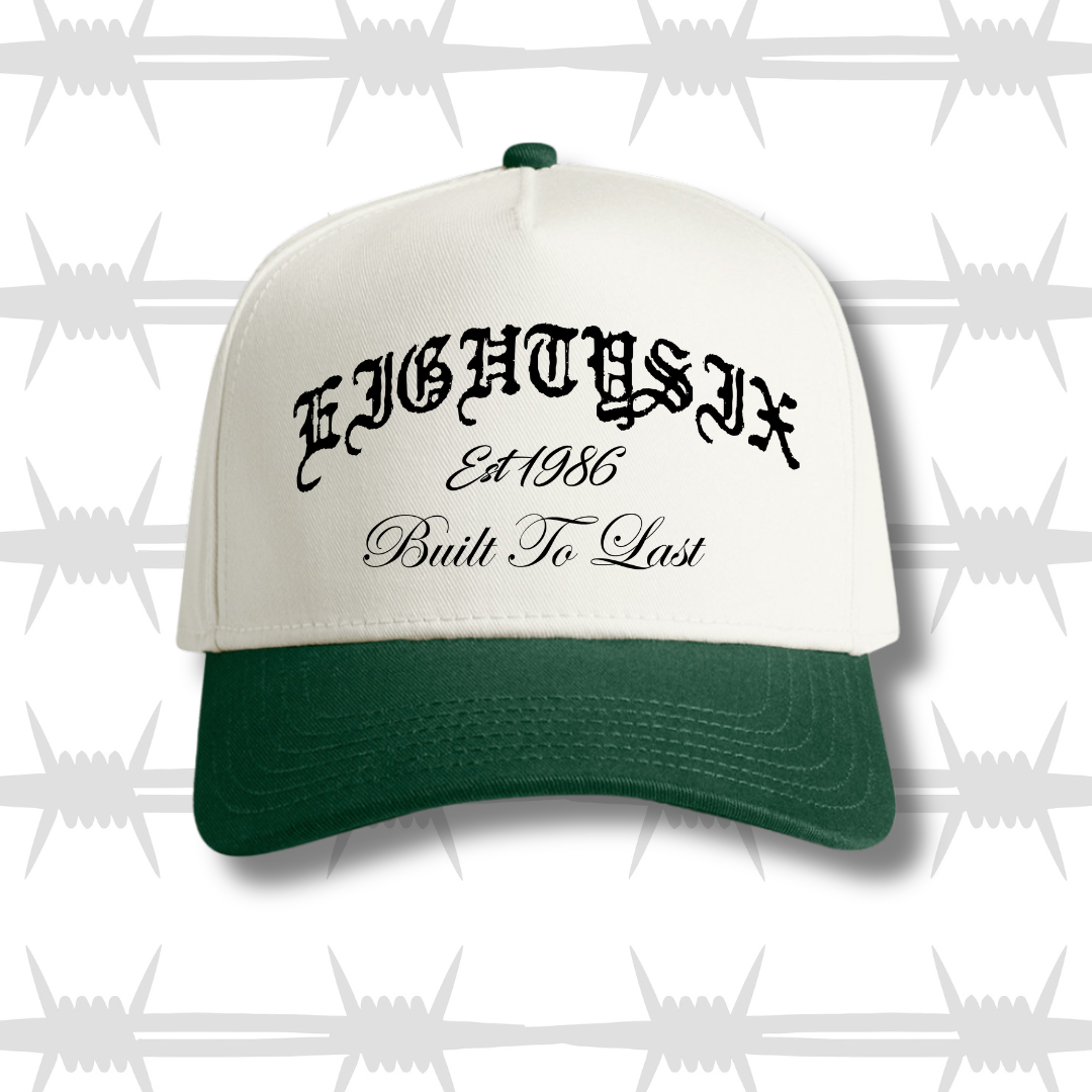 two tone cap with forest green peak featureing the eightysix logo and built to last script