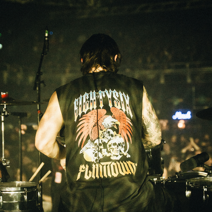 eightysix x flinttown tank from the back worn by the drumer from the band you me at six while playing drums at a live gig