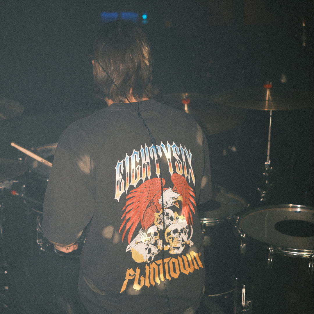 Eightysix X flinttown t-shirt worn by the drummer of You Me At Six Dan Flint while playing a gig with the band
