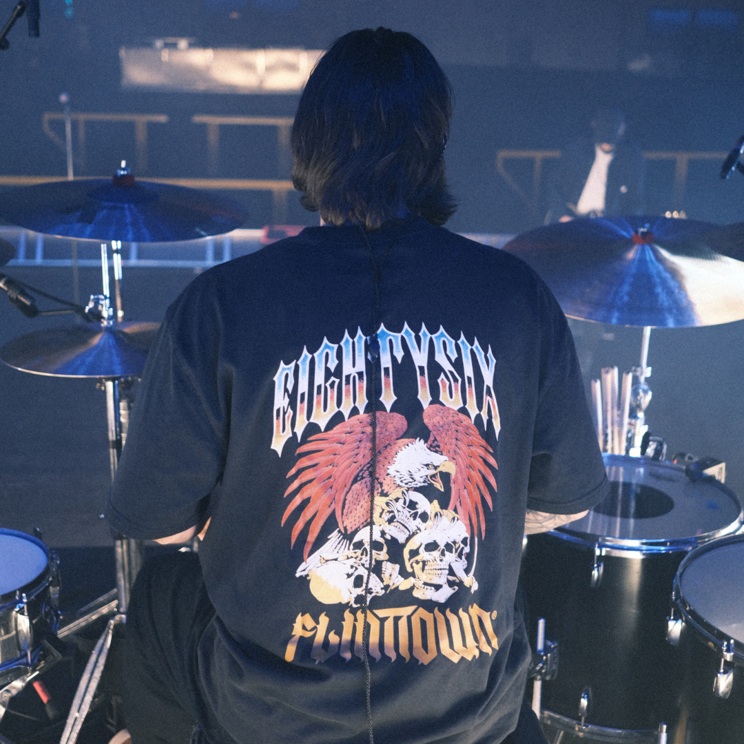 Eightysix x Flittown t-shirt shown from the back, worn by the drummer from You Me At Six while playing a gig