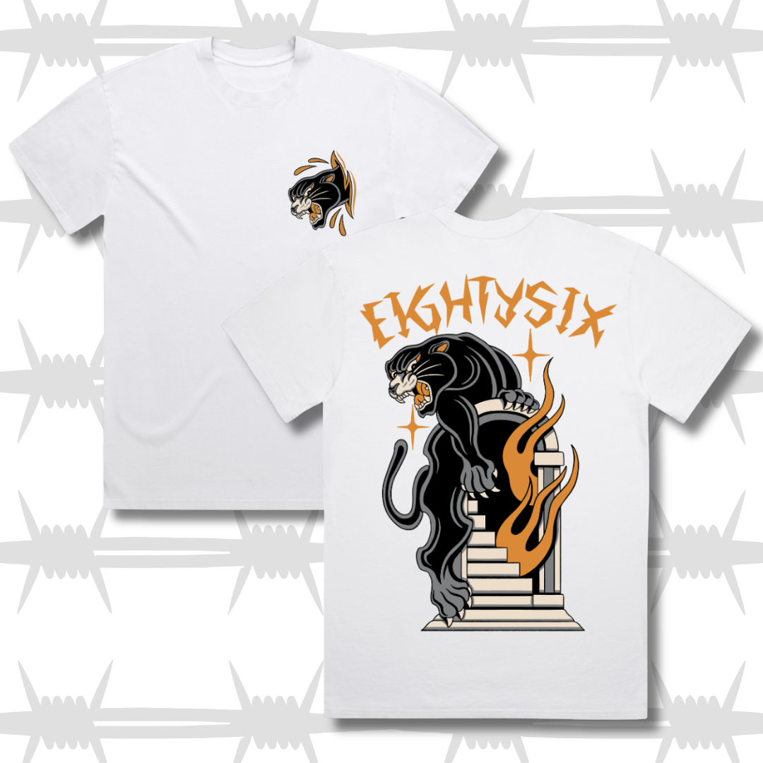 White graphic t-shirt featuring a panther and a flaming doorway in a traditional tattoo style on the back and a skin rip panther head on the front.