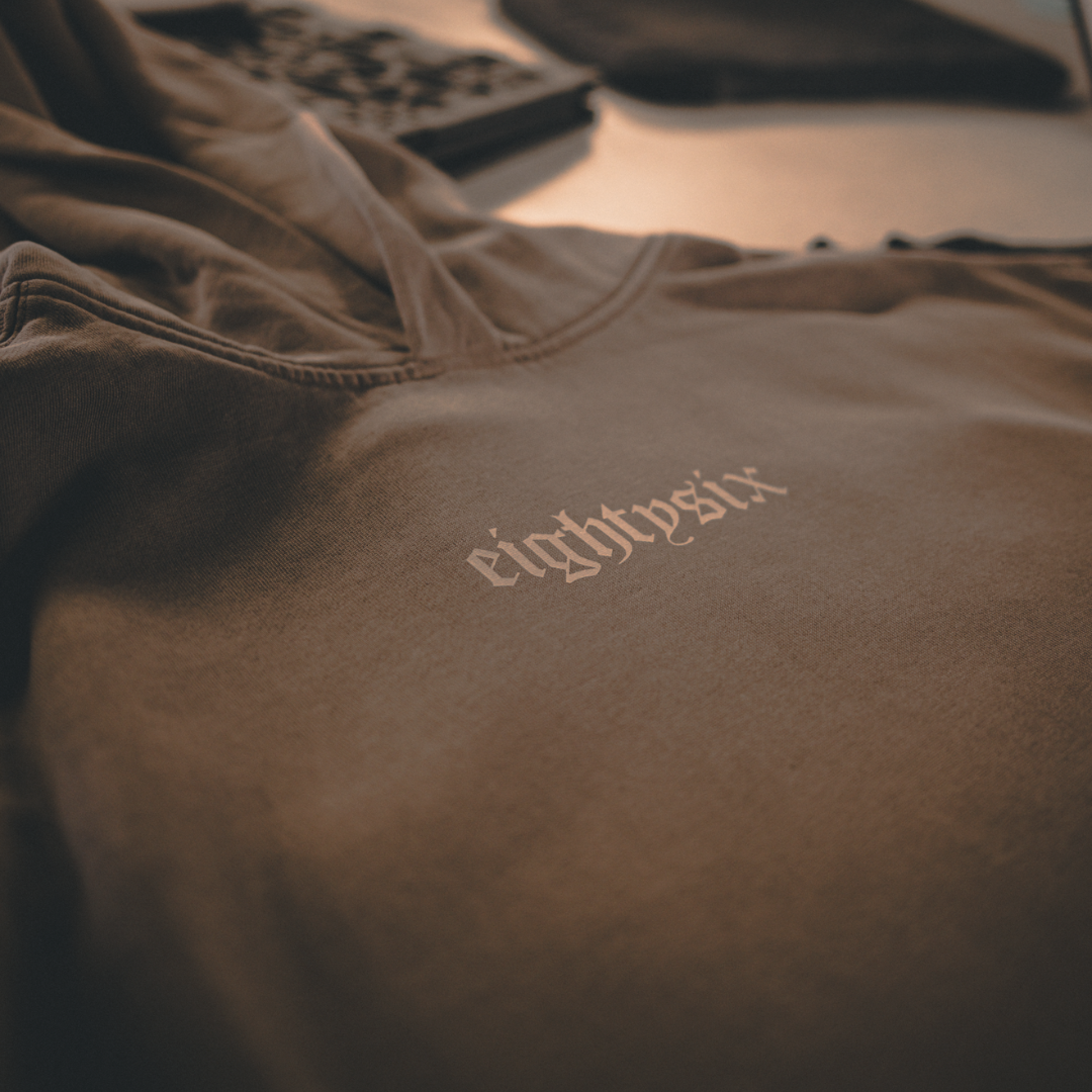 Grey hoodie with eightysix in white on front and tattoo inspired reaper design in the style of a king playing card