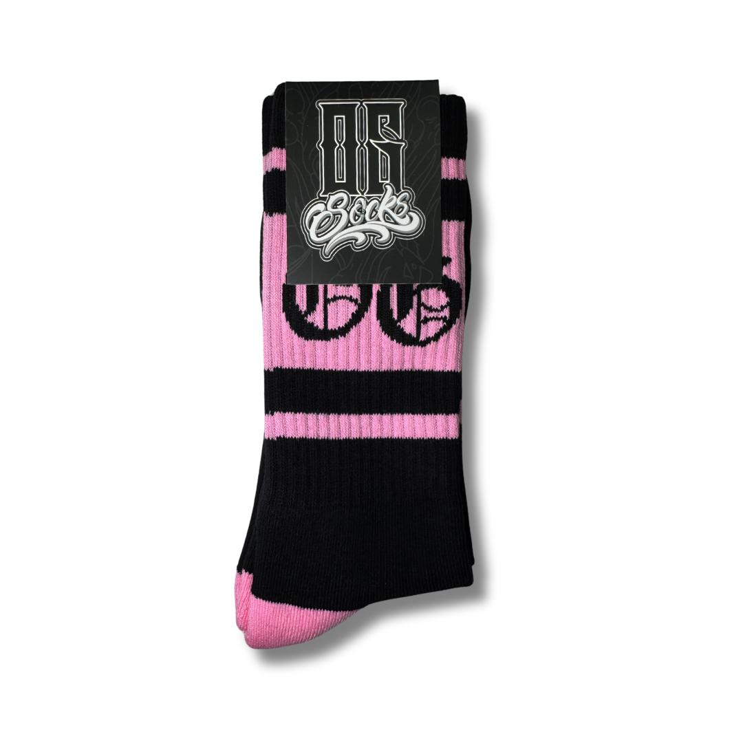Black socks with 3 bubblegum pink stripes and a black OG logo, in the og sock packaging