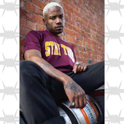 Eightysix streetwear stay true varsity t-shirt in burgundy worn by tattooed model