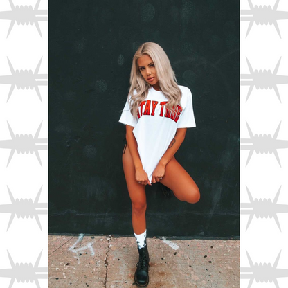 Stay True Varsity graphic t-shirt in white with orange stay true worn bu tattooed alternative lifestyle model