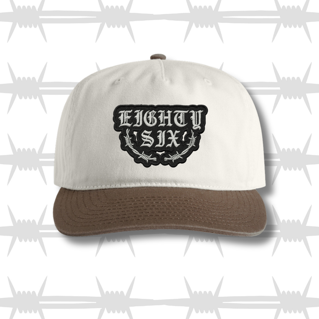 Two tone brown and white cap with embroidered eightysix logo with a barbed wire accent front shot