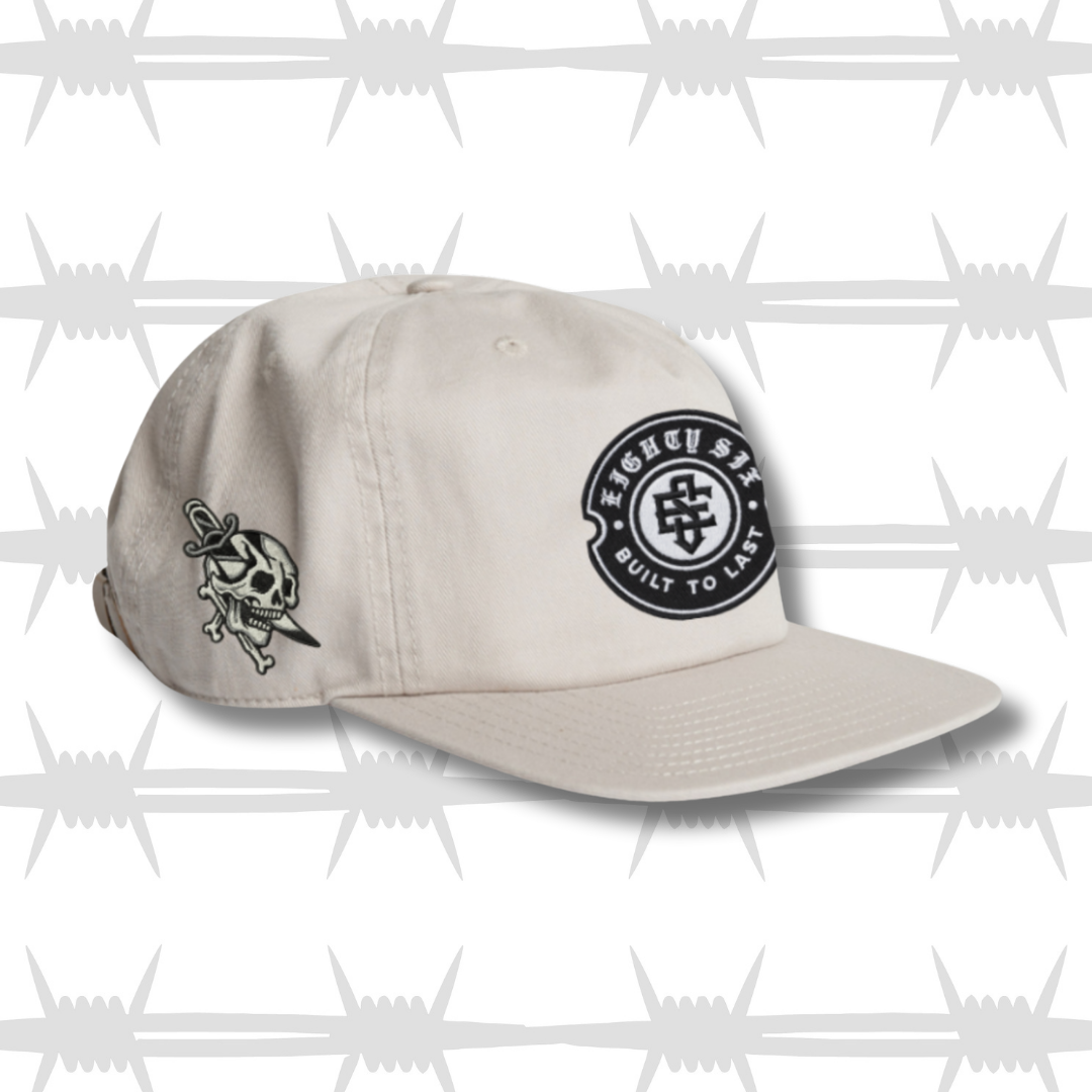 Black work cap with embroidered crest eightysix logo with dagger and skull tattoo inspired design