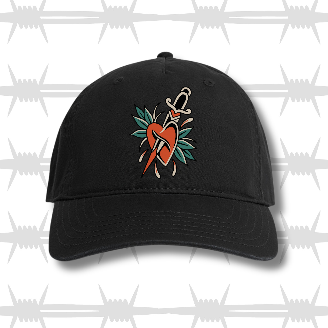 Black dad cap with heart and dagger design in a trad tattoo style