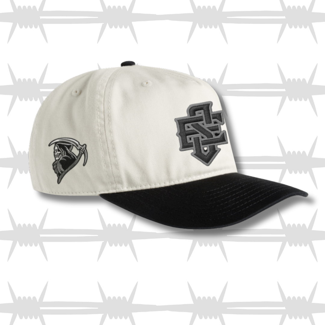 Black and white two tone cap with embroidered ES logo and tattoo inspired reaper design on the side