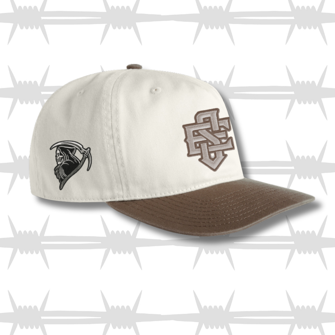 brown and white two tone cap with embroidered ES logo and tattoo inspired reaper design on the side